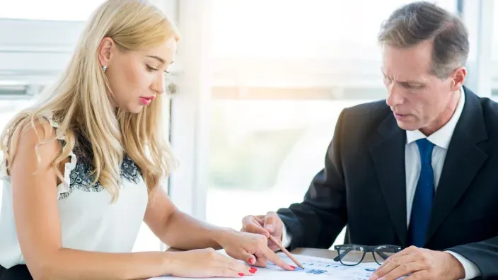 Manos con libretas y móviles planificando un proyecto o negocio.