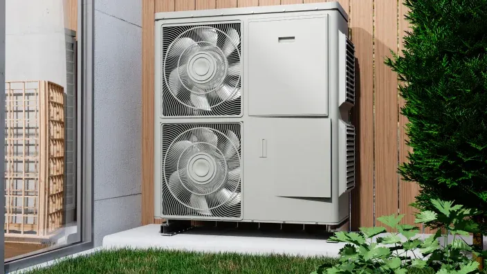Bomba de calor instalada en el exterior de una vivienda para mejorar la eficiencia energética.