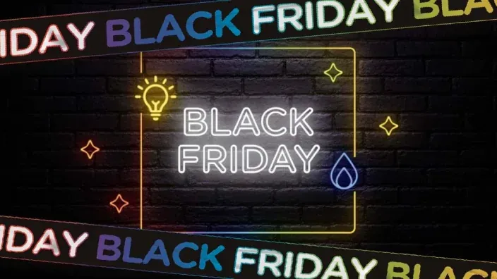 Cartel de estilo neón con el texto Black Friday y símbolos de luz y energía sobre una pared oscura.
