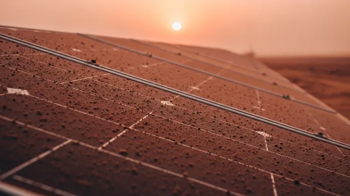 Placas solares cubiertas de polvo durante el amanecer, reduciendo su eficiencia en verano.