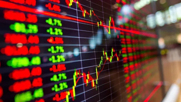Panel de cotizaciones bursátiles con cifras en rojo y verde y varias gráficas