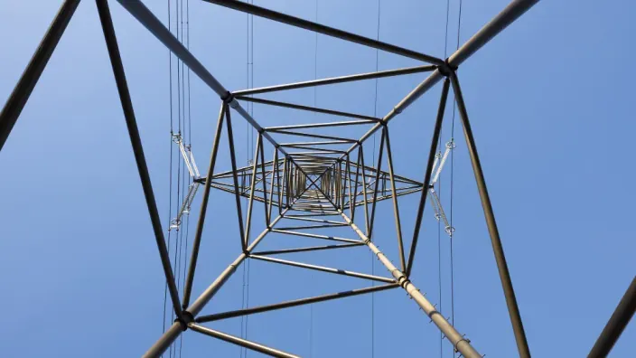 Vista en contrapicado de una torre de alta tensión de la red eléctrica, responsable del transporte de la energía.