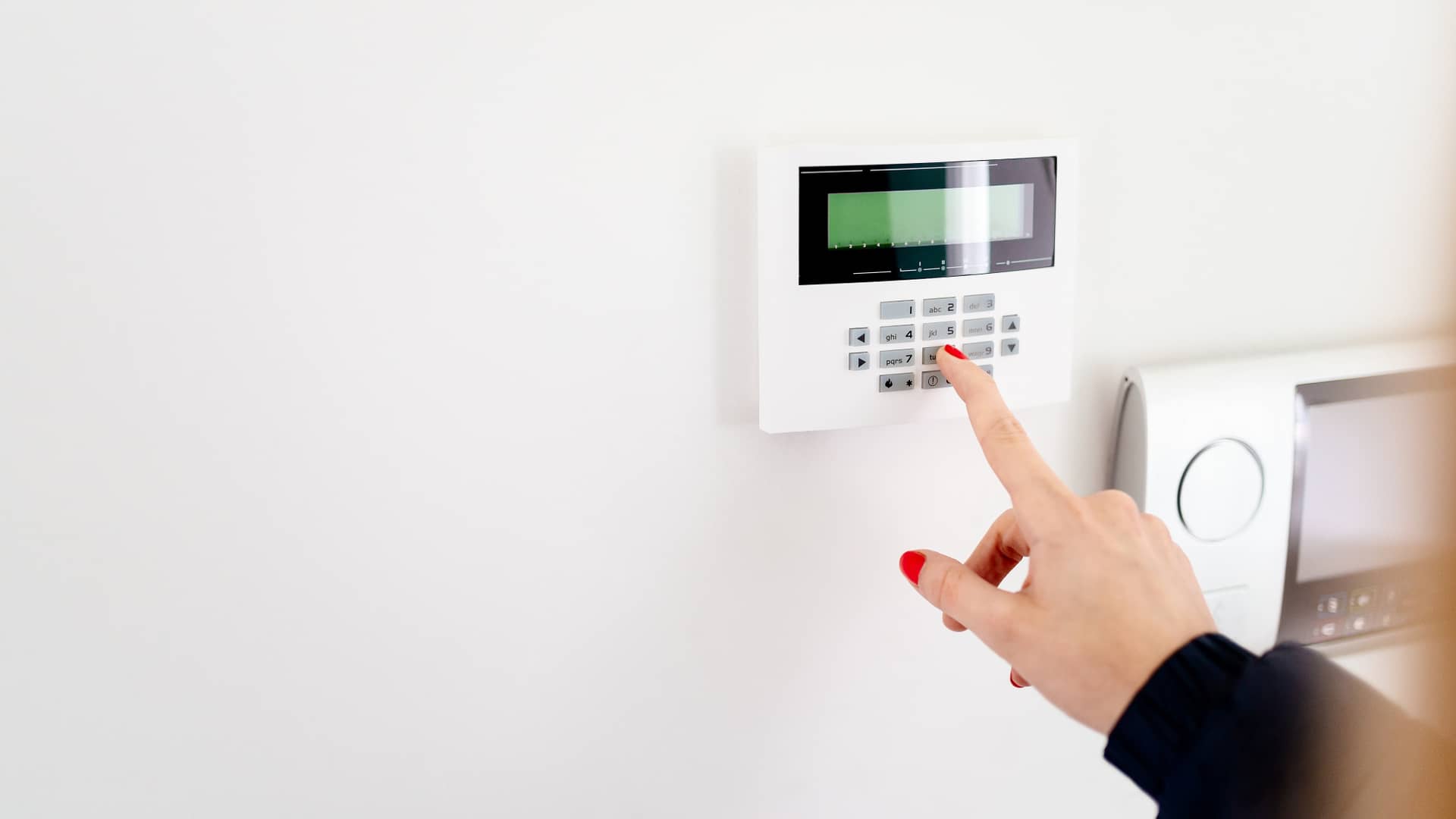 Persona desactivando alarma en panel de control de vivienda