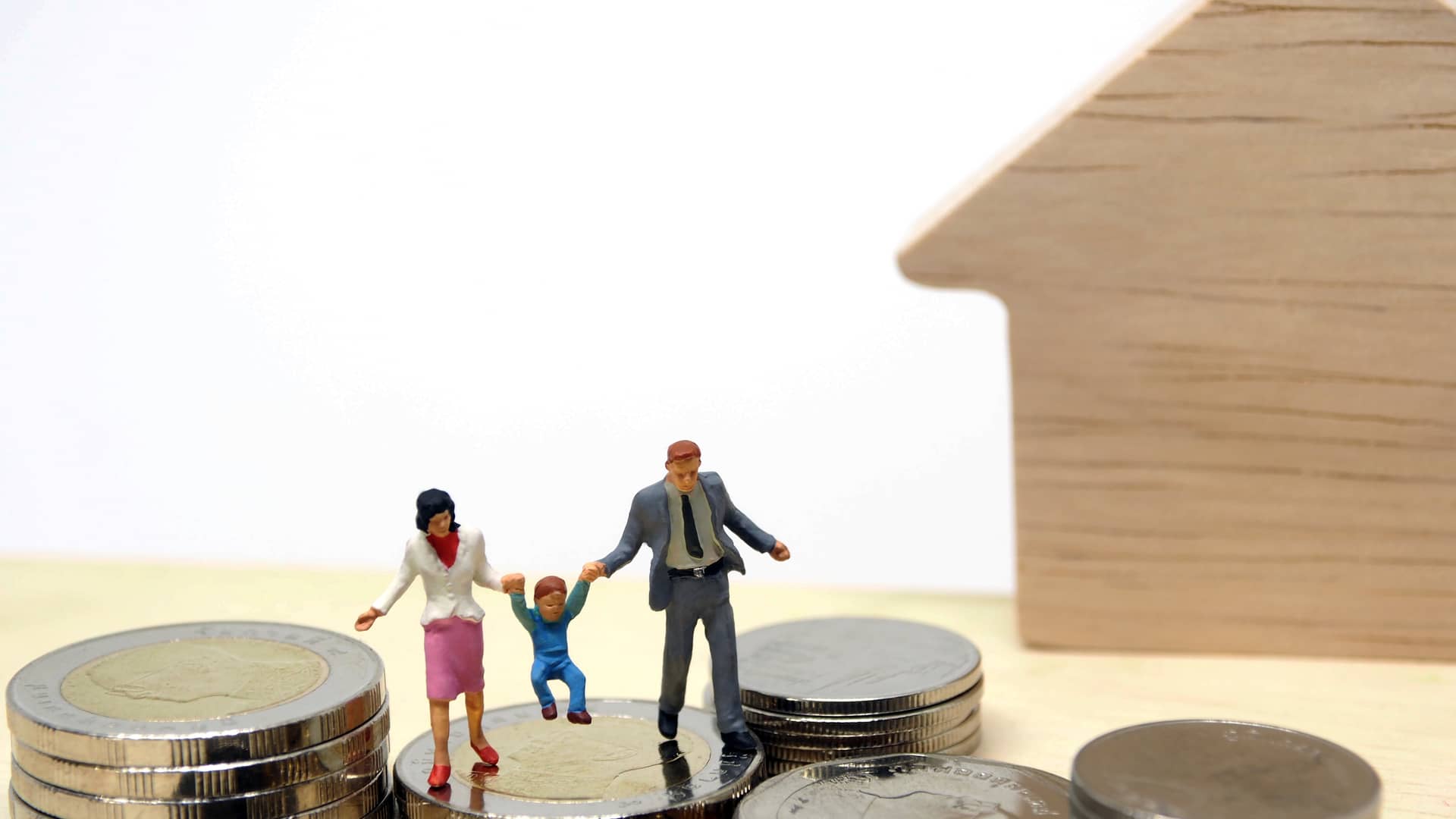 Familia de muñecos encima de montañas de dinero que han obtenido al reclamar su clausula suelo con kutxabank