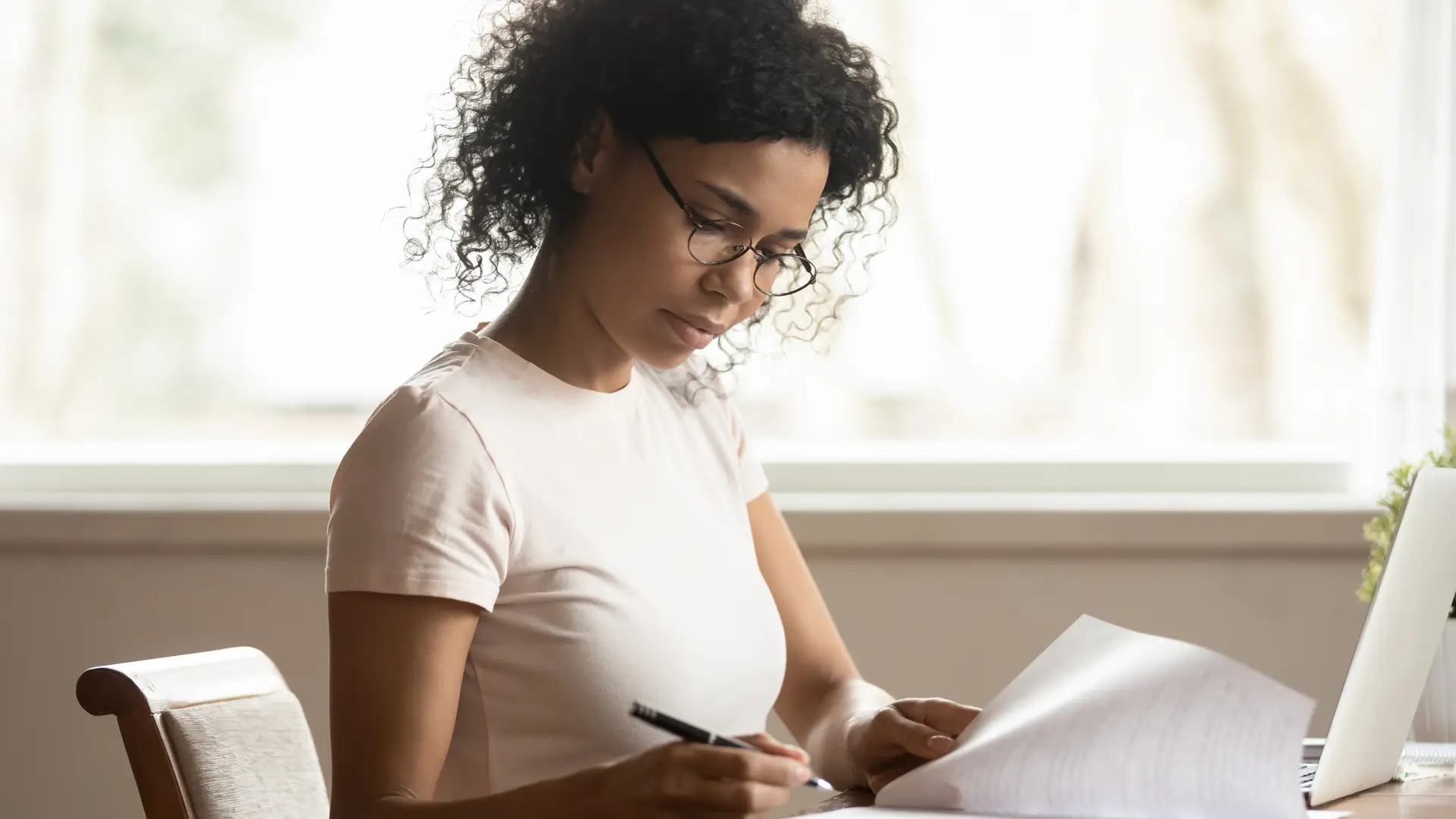 chica rellenando los papeles para poner una reclamacion a su aseguradora reale seguros