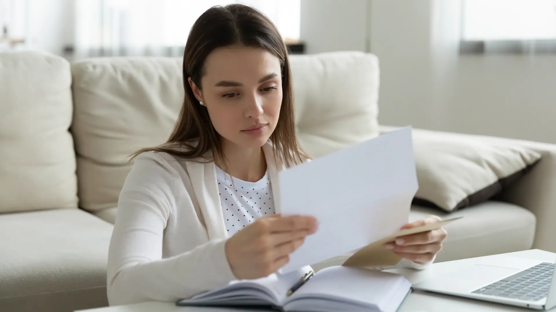 Una mujer revisando un recibo que debe pagar por el arrendamiento de una casa