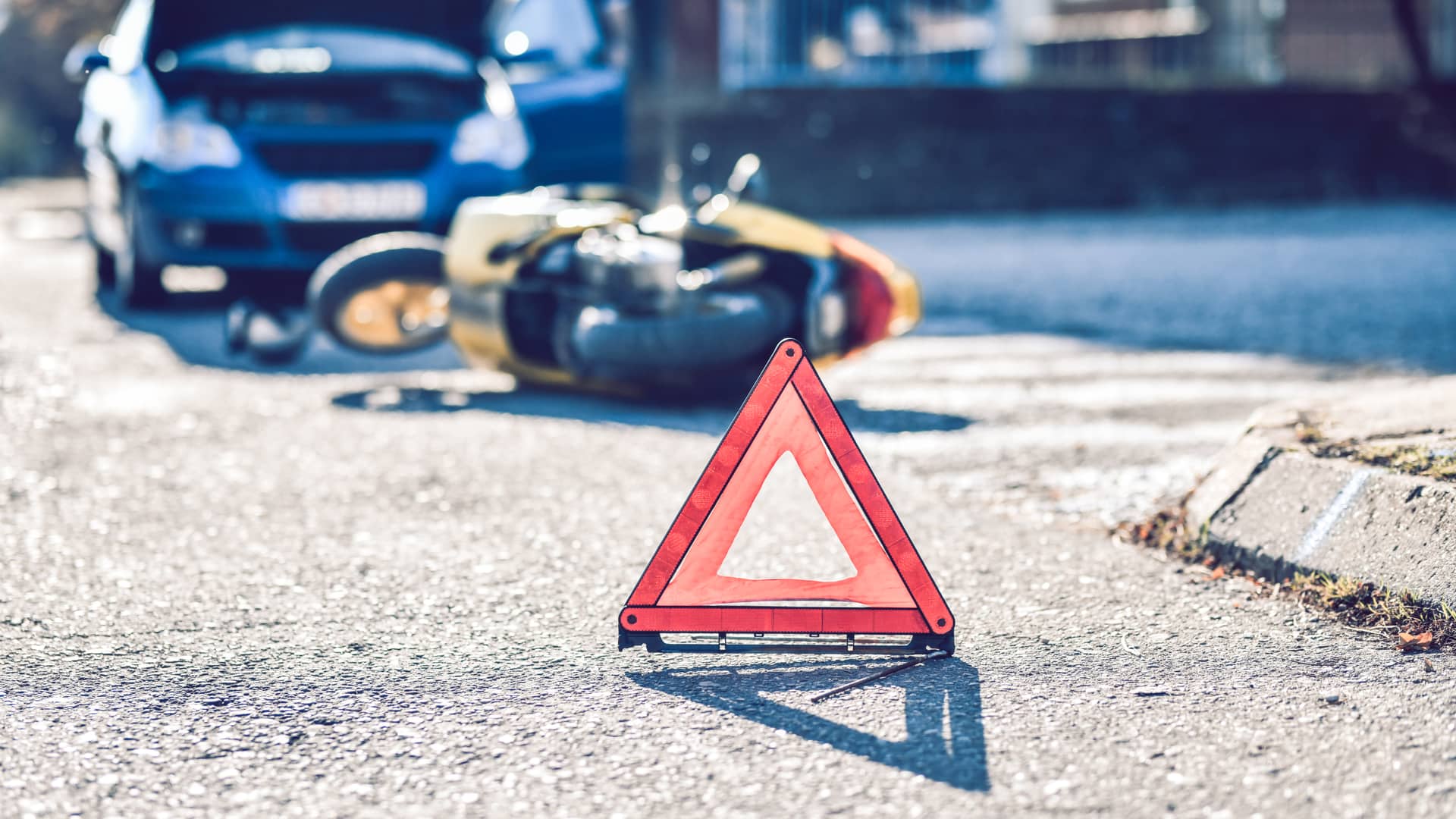 Triangulos puestos para que los condcutores tengan precaución porque ha ocurrido un accidente entre un coche y una moto con seguro Triangulos puestos para que los condcutores tengan precaución porque ha ocurrido un accidente entre un coche y una moto con seguro