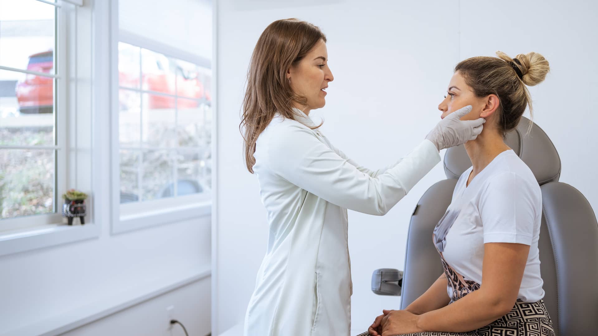 Dermatóloga que realiza un procedimiento en un cliente con seguro de salud Dermatóloga que realiza un procedimiento en un cliente con seguro de salud