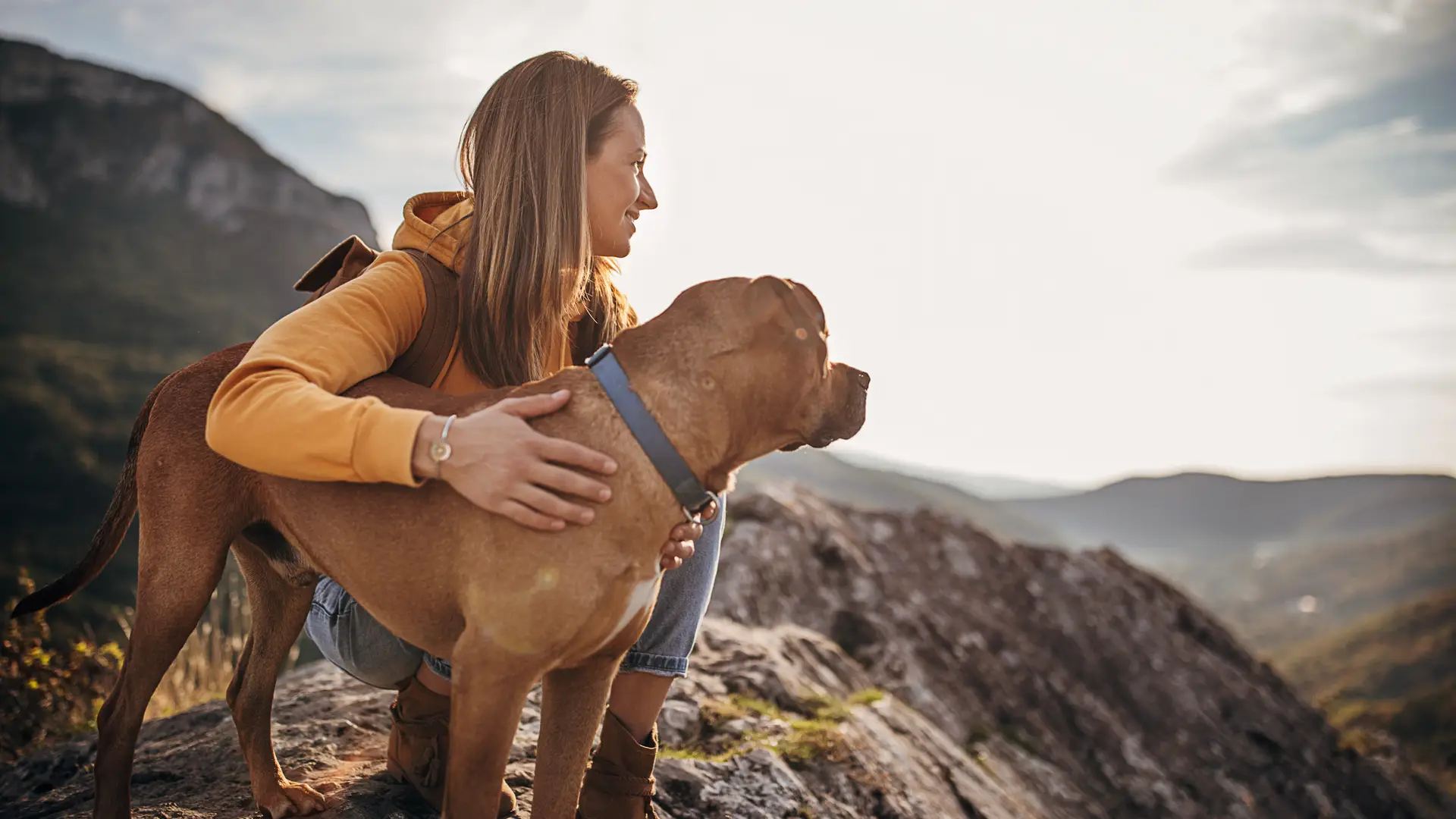Mujer haciendo una ruta con su perro al cual le ha contratado un seguro de viaje Mujer haciendo una ruta con su perro al cual le ha contratado un seguro de viaje