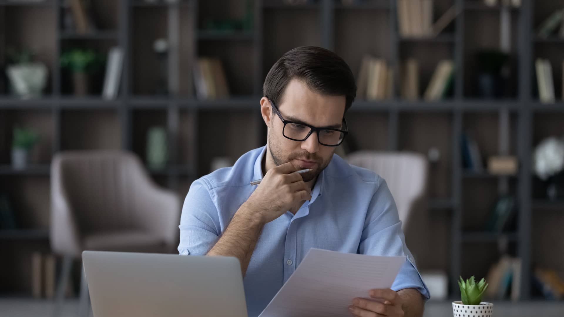 Un hombre muy serio leyendo unos papeles sobre la inembargabilidad de su seguro de vida Un hombre muy serio leyendo unos papeles sobre la inembargabilidad de su seguro de vida