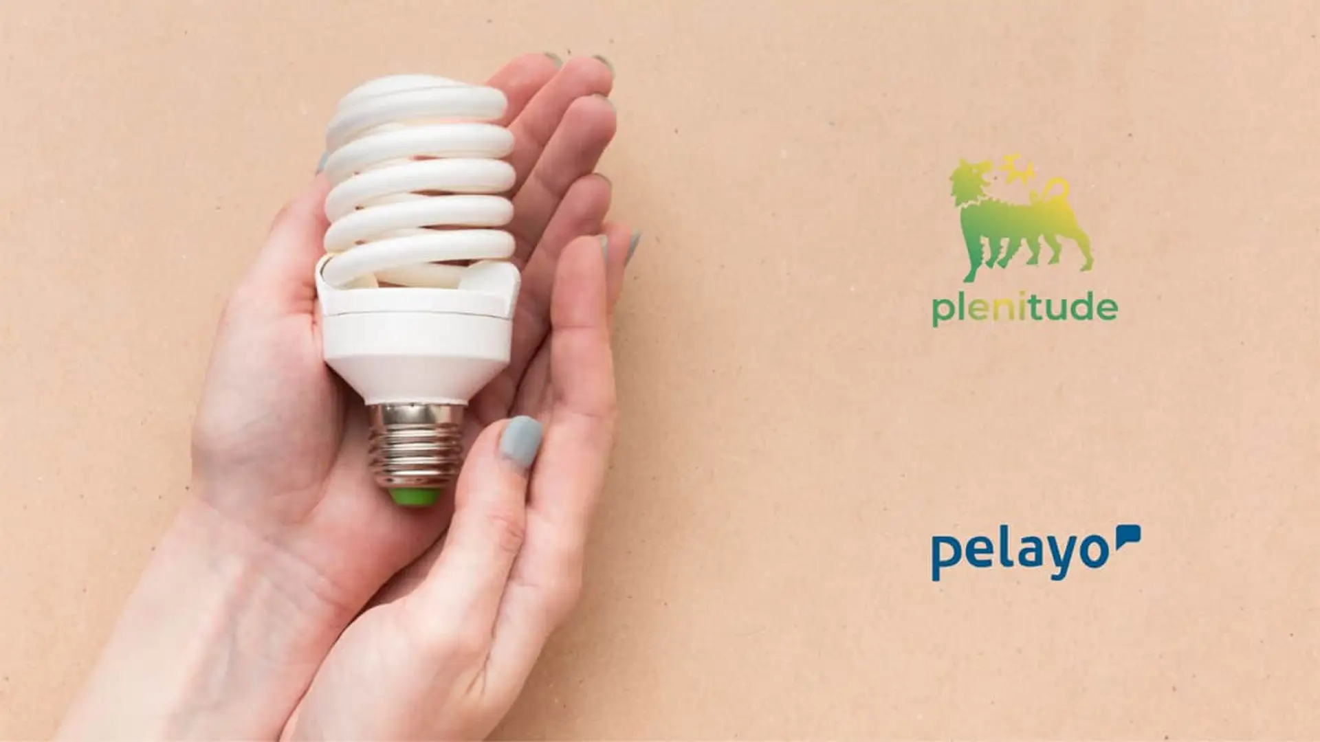 Manos con bombilla junto a logos de Plenitude y Pelayo para representar acuerdo de comercialización.