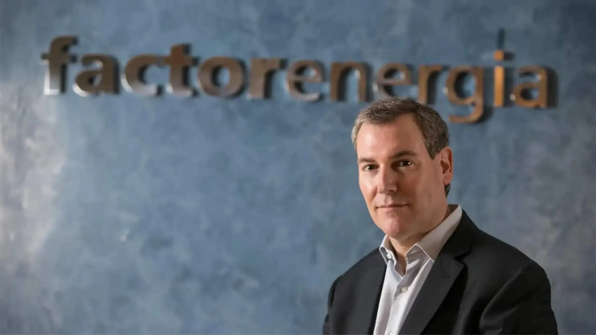 Emili Rousaud, CEO de Factor Energía, en un retrato con el logo de la comercializadora de fondo.