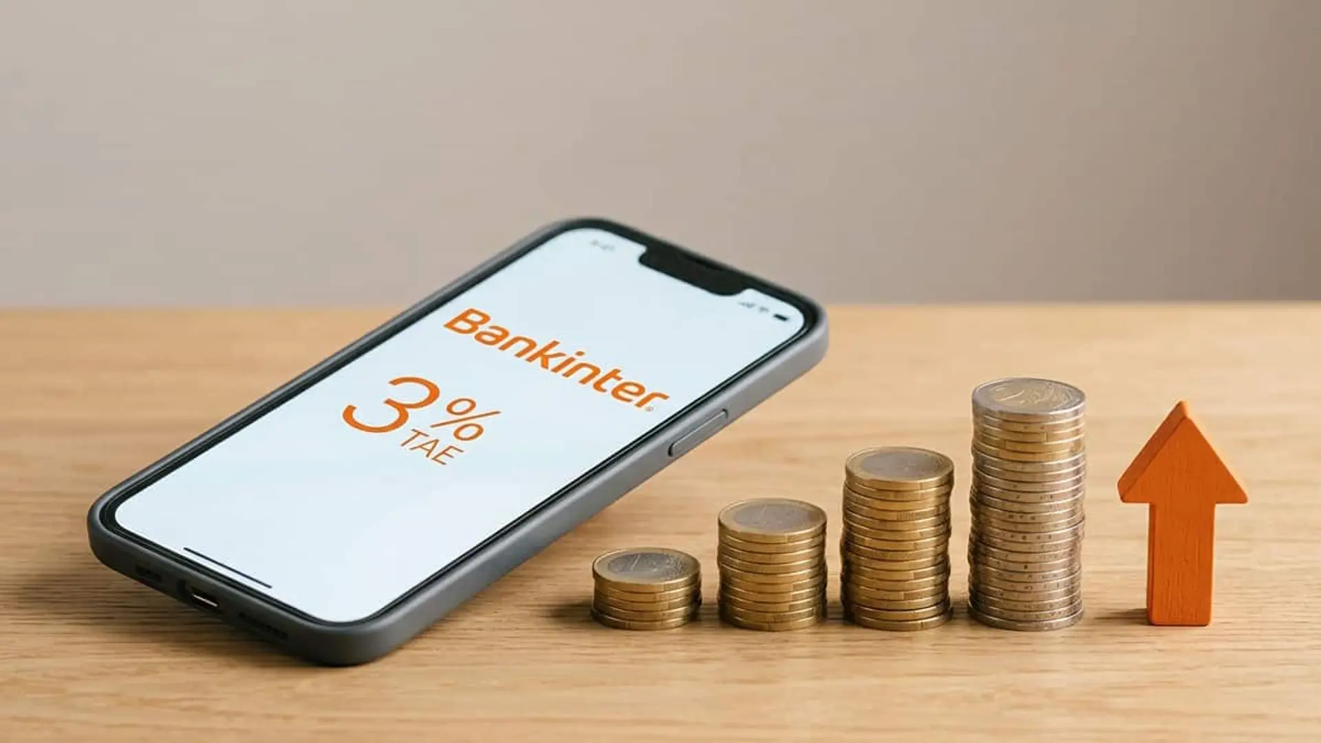 Móvil con Bankinter y una remuneración del 3% TAE junto a varias pilas de monedas en crecimiento