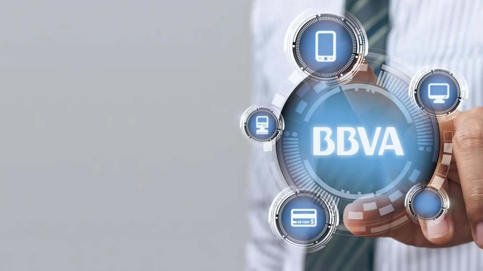 Así es la nueva herramienta de BBVA que permite a las empresas controlar su tesorería en tiempo real Mano de un ejecutivo señalando el logo de BBVA en una interfaz digital con iconos de móvil, tablet y tarjeta de crédito.