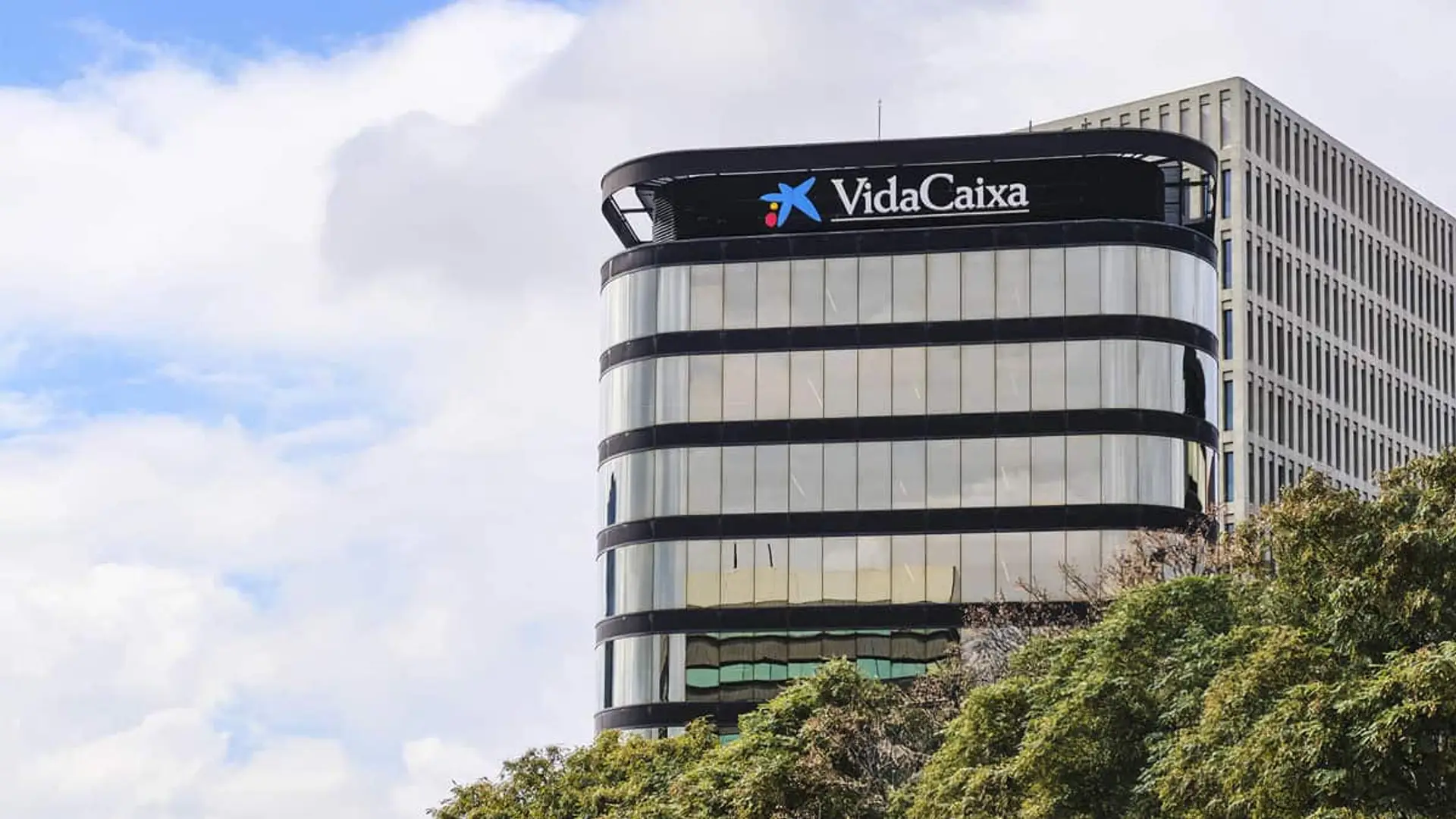 La banca se beneficia de los seguros de no vida: su negocio aumenta 2.000 millones en un año Fachada del edificio corporativo de VidaCaixa en Barcelona bajo un cielo parcialmente nublado.
