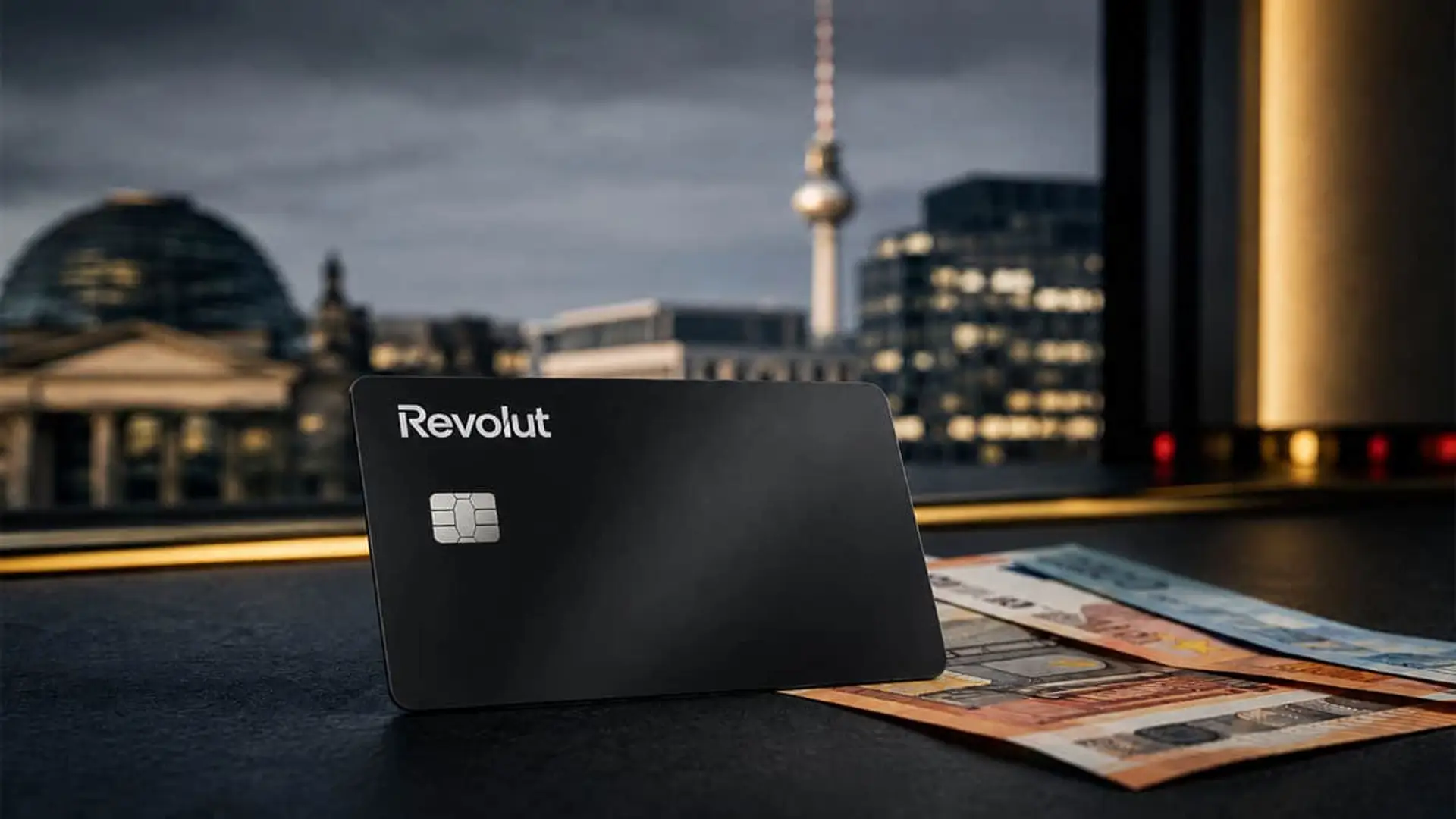 Revolut sube al 4,25% su cuenta remunerada y ataca el mercado alemán Tarjeta Revolut junto a billetes de euro con Berlín y la torre de televisión al fondo.