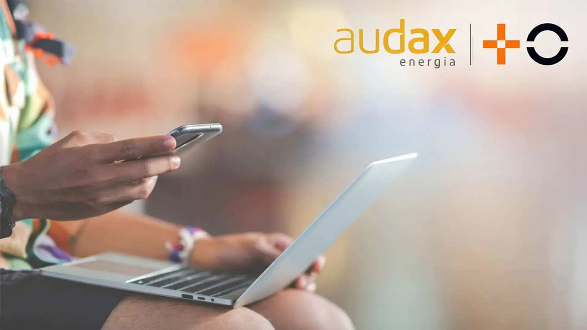 La energética de José Elías entra en telefonía con MasOrange: así quiere competirle a DIGI, O2 y Lowi Usuario con móvil y portátil junto a los logos de Audax Energía y MasOrange para ofertas de fibra óptica, luz y gas.