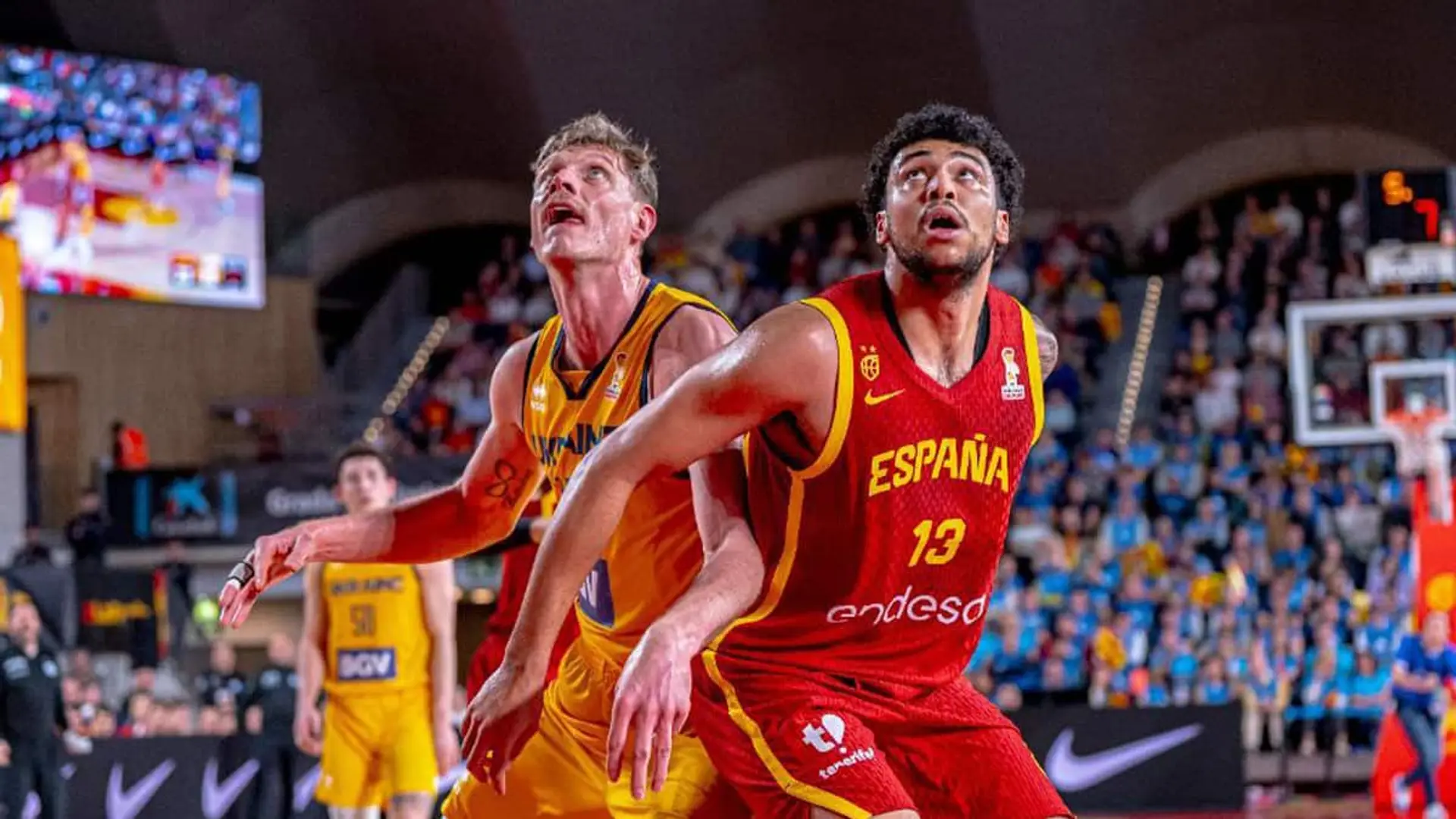 Jugador de la selección española masculina de baloncesto luchando por el rebote ante un rival en un encuentro internacional.