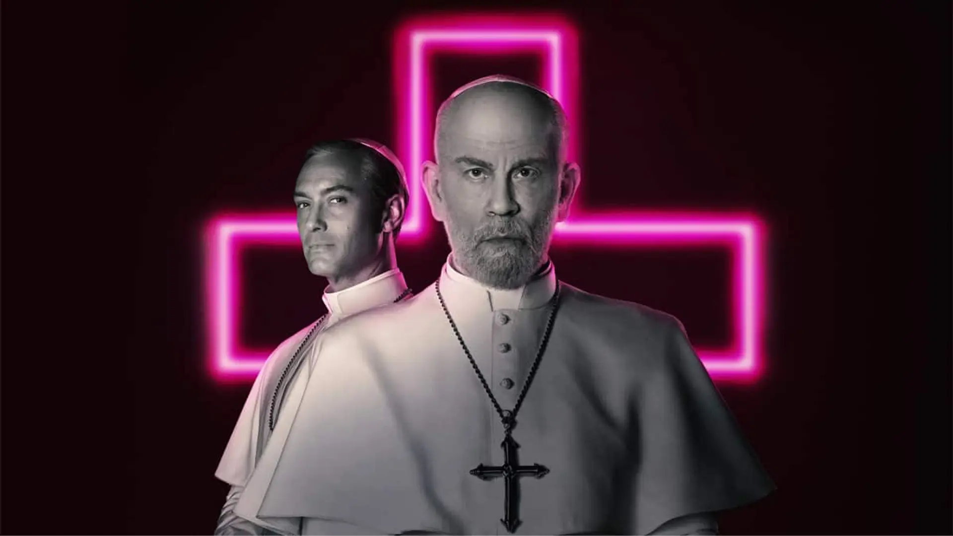 Imagen promocional de la serie The New Pope con Jude Law y John Malkovich por delante de una cruz católica de neón.