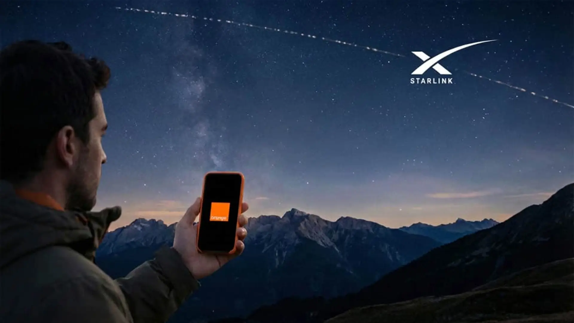 Móvil Orange bajo cielo estrellado con satélites Starlink en la montaña.