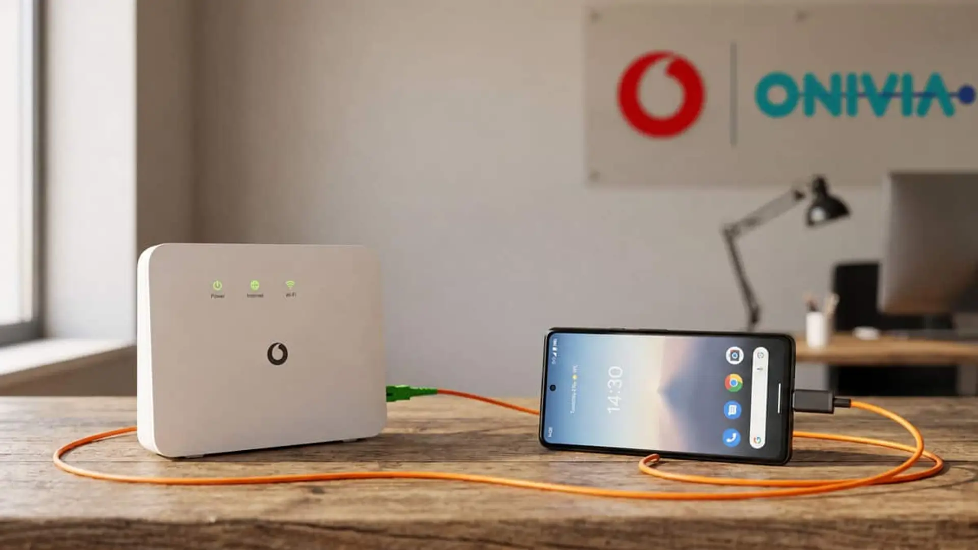 Router de Vodafone conectado por cable junto a un móvil en una oficina de Onivia