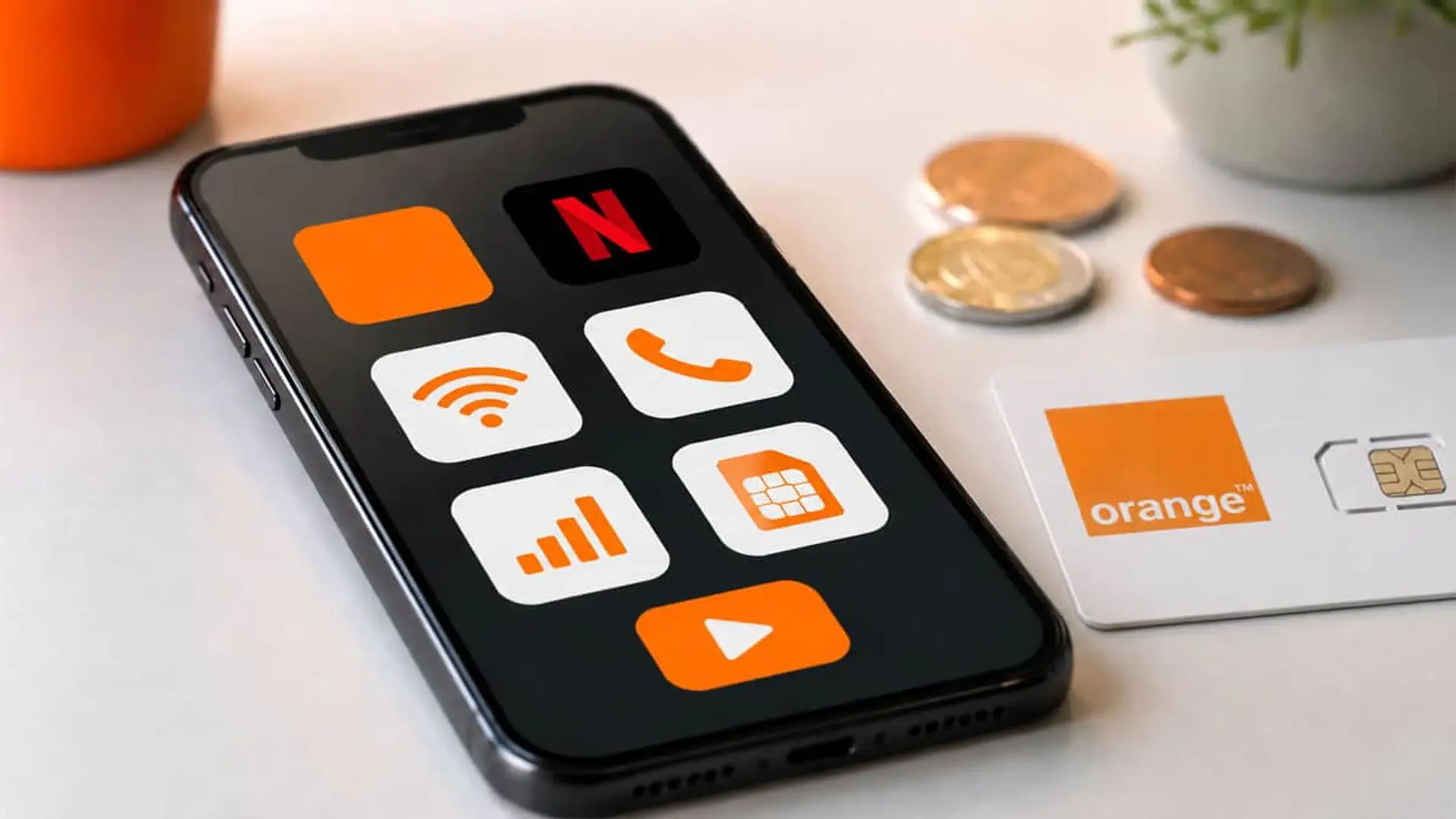 Smartphone con apps de streaming y servicios móviles Orange junto a tarjeta SIM