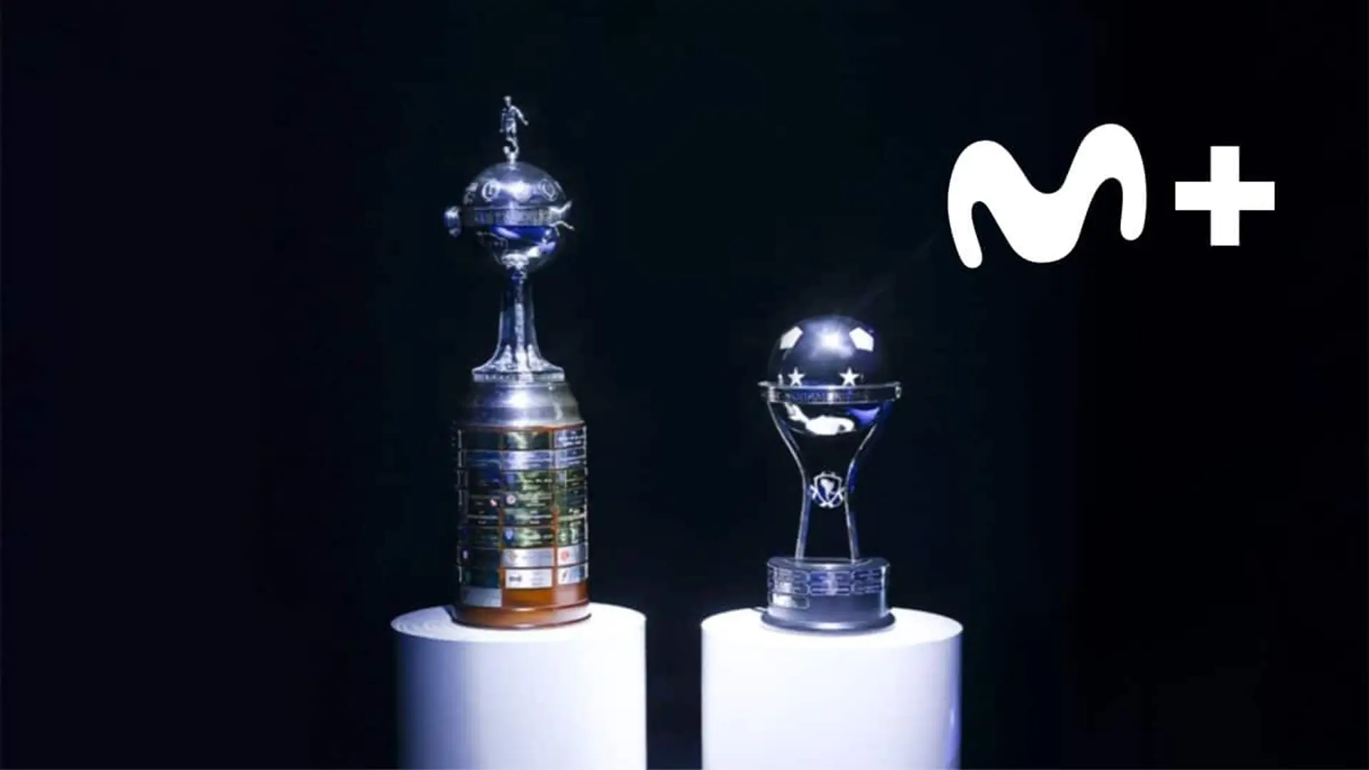 Los trofeos de la Copa Libertadores y la Copa Sudamericana sobre pedestales junto al logotipo de Movistar Plus