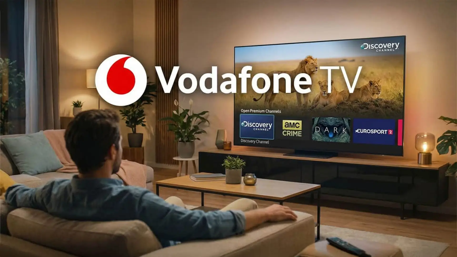 Hombre viendo el canal Discovery en la interfaz de Vodafone TV con el logotipo de la marca.