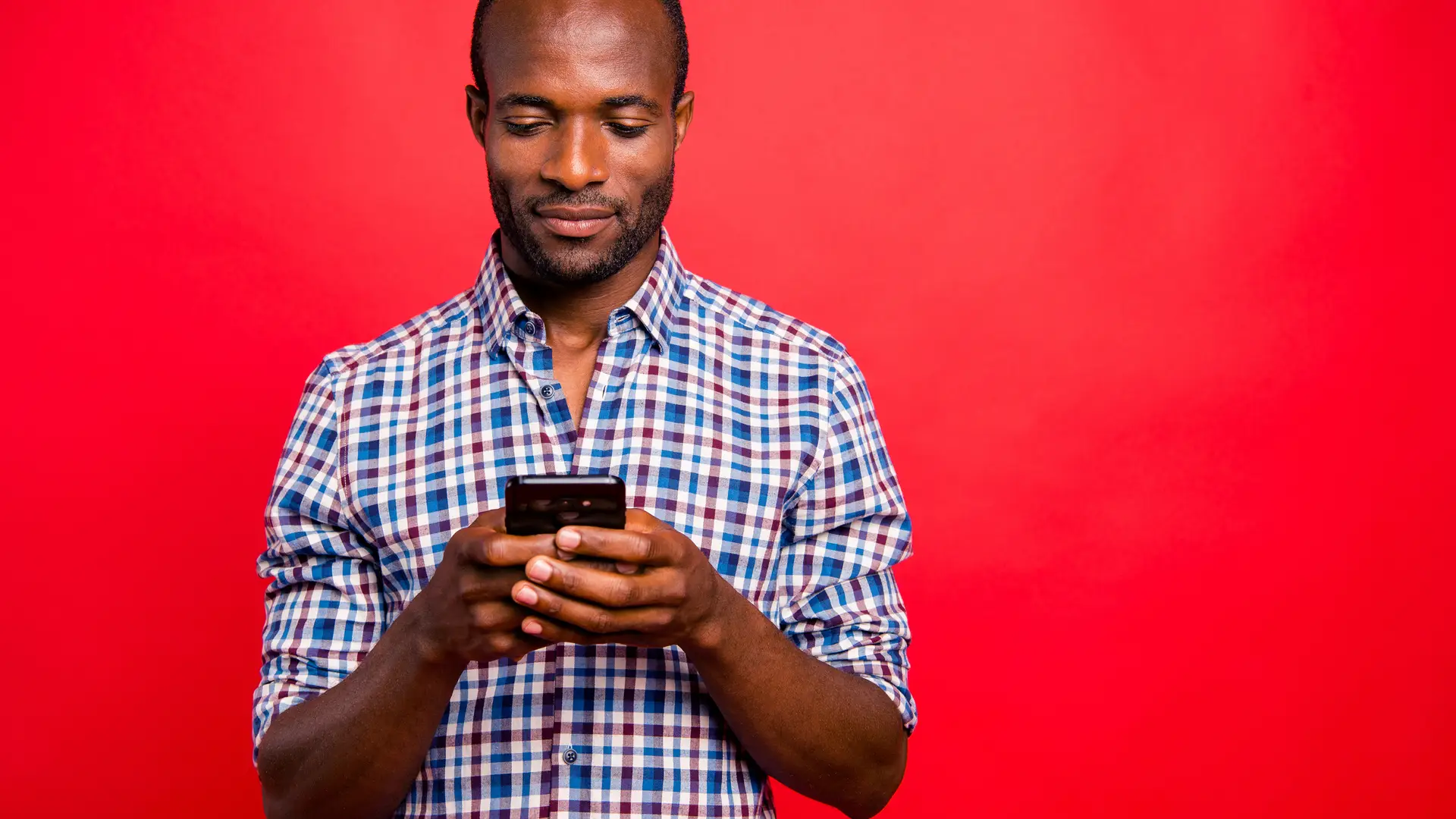 Joven viendo en su smartphone las tarifas que ofrece holafly Joven viendo en su smartphone las tarifas que ofrece holafly