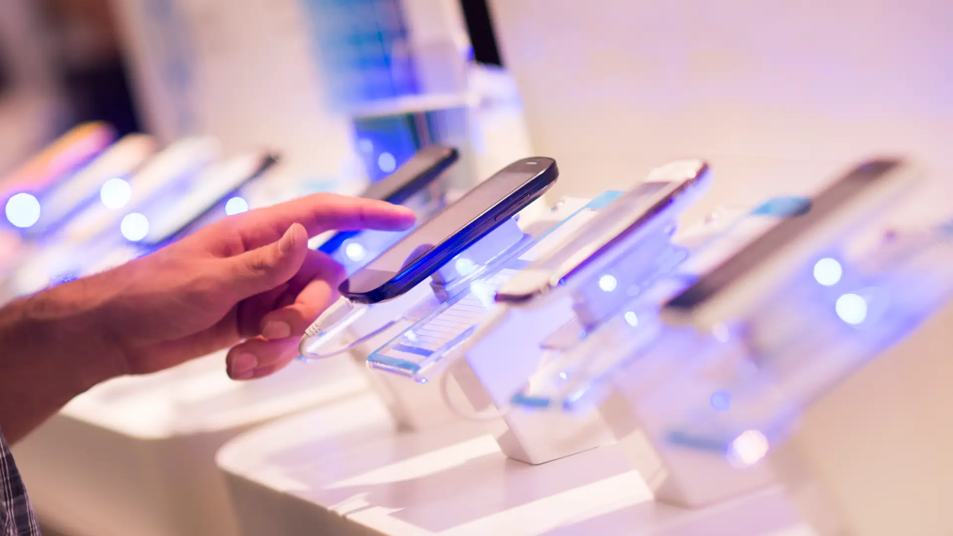 Persona valorando un teléfono móvil en una tienda jazztel Persona valorando un teléfono móvil en una tienda jazztel