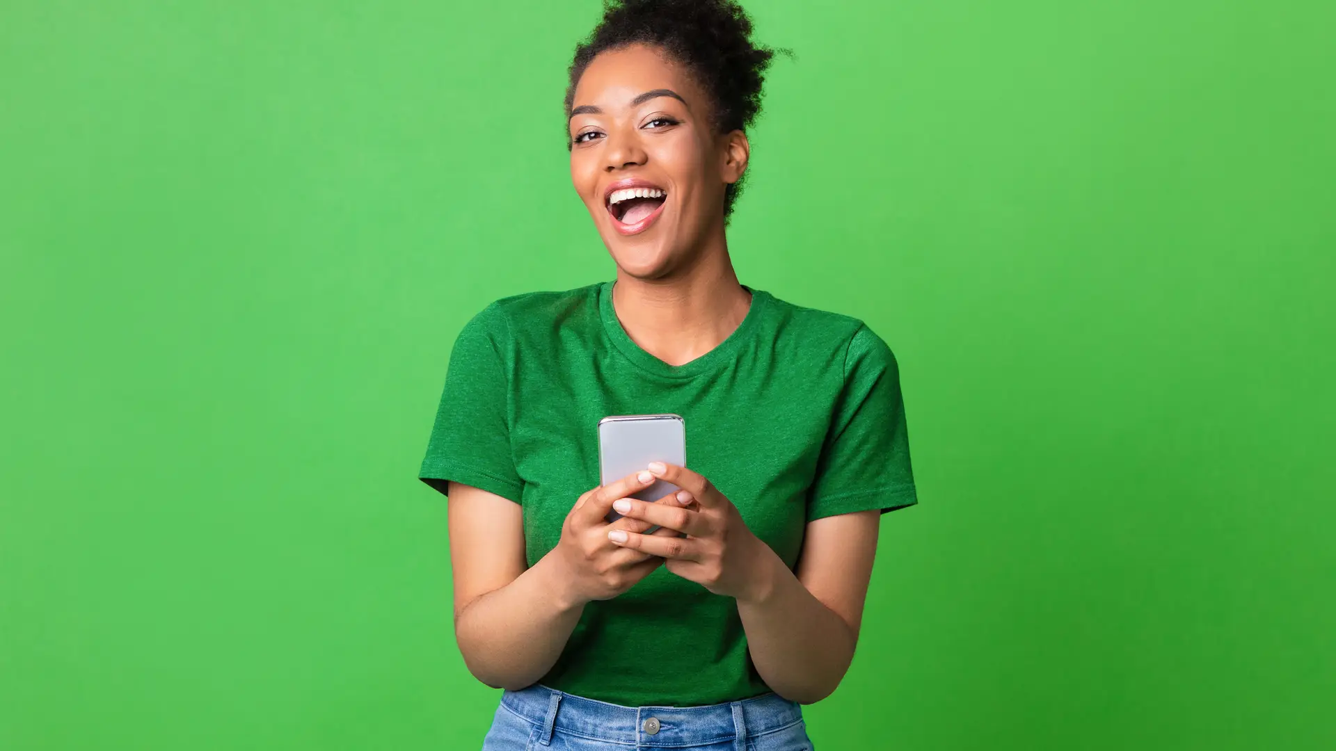 Joven sonriente con smartphone viendo tarifas lycamobile Joven sonriente con smartphone viendo tarifas lycamobile