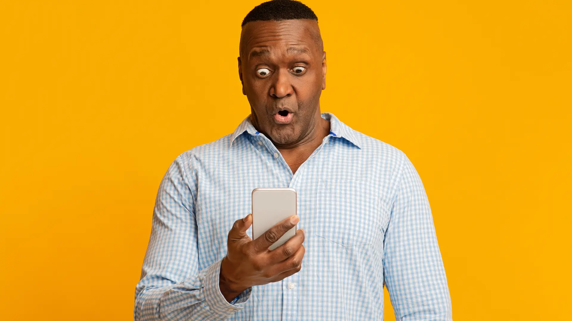 Hombre con su smartphone con cara de asombro al descubrir las ofertas renove de orange Hombre con su smartphone con cara de asombro al descubrir las ofertas renove de orange